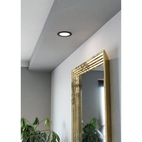 Gosmelle LED Downlight, 11.9cm round fitting with black trim and white diffuser, recessed into a pale ceiling near a gold-framed mirror in a hallway setting.