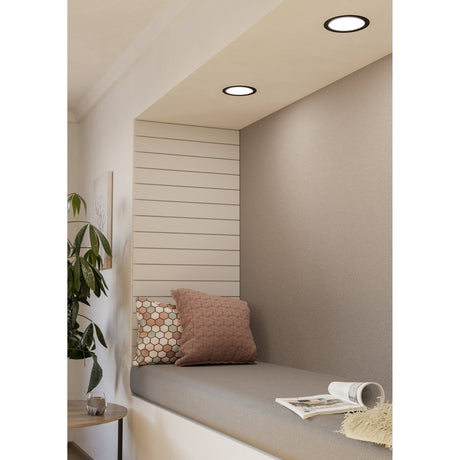 Gosmelle LED Downlight, round recessed fixture with black steel ring and white diffuser, shown installed in a ceiling niche above a seating nook, 16.6cm, cool white, IP20.