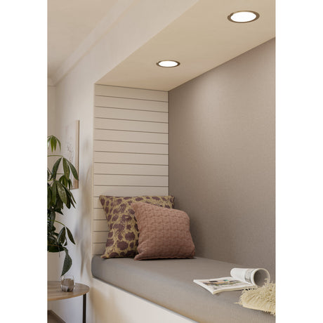 Gosmelle LED downlight with satin nickel bezel and white diffuser recessed into a ceiling nook above a cushioned window seat with patterned pillows.