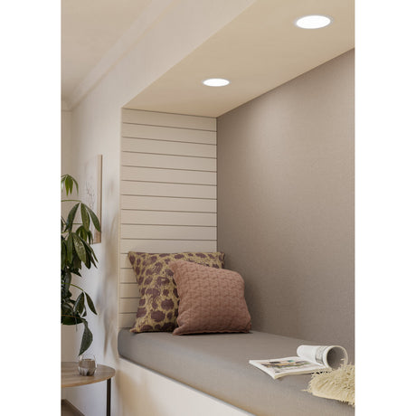 Gosmelle round LED downlights, 11W warm white IP20, recessed in a white ceiling above a cushioned window nook with patterned cushions.