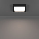 Gosmelle square LED downlight, 15 x 15cm surface-mounted ceiling panel with black plastic frame and white diffuser, IP44 rated, shown lit on a grey ceiling.