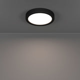 Gosmelle LED downlight in black plastic with round white diffuser, mounted on a grey ceiling and casting warm light downward, IP44 rated, 16.6 x 2.5cm.