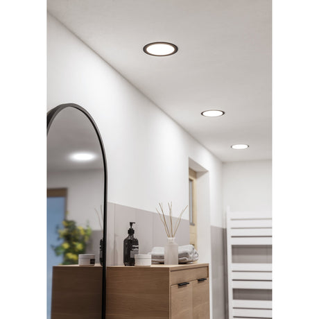 Gosmelle LED downlight with black trim and white diffuser recessed into a bathroom ceiling above a wood vanity and arched mirror.