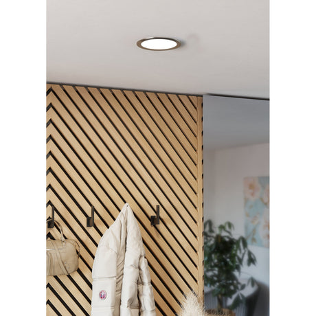 Gosmelle LED Downlight 16.8cm in satin nickel, round recessed fixture with white diffuser, shown lit in a white ceiling above a wood-slatted hallway wall with hooks.