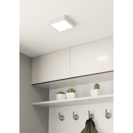 Gosmelle square LED downlight in white steel with a flush ceiling mount, shown above kitchen cabinets with a shelf, potted plants and coat hooks below.