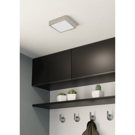 Gosmelle LED Downlight, a slim square ceiling fixture in satin nickel with a white diffuser, shown fitted to a kitchen ceiling above dark wall cabinets and a shelf.