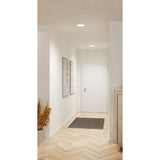 Gosmelle round LED downlights, white finish, recessed into a hallway ceiling providing warm white light above a white door and framed artwork.