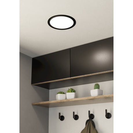 Gosmelle LED Downlight, round with black steel rim and white diffuser, fitted flush in a ceiling above dark kitchen cabinets and a wooden shelf with coat hooks.