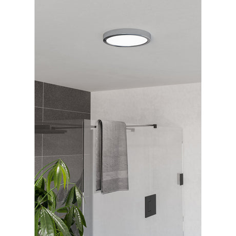 Gosmelle LED Downlight 21.1cm in chrome with white diffuser, mounted on a bathroom ceiling above a glass shower enclosure and towel rail.