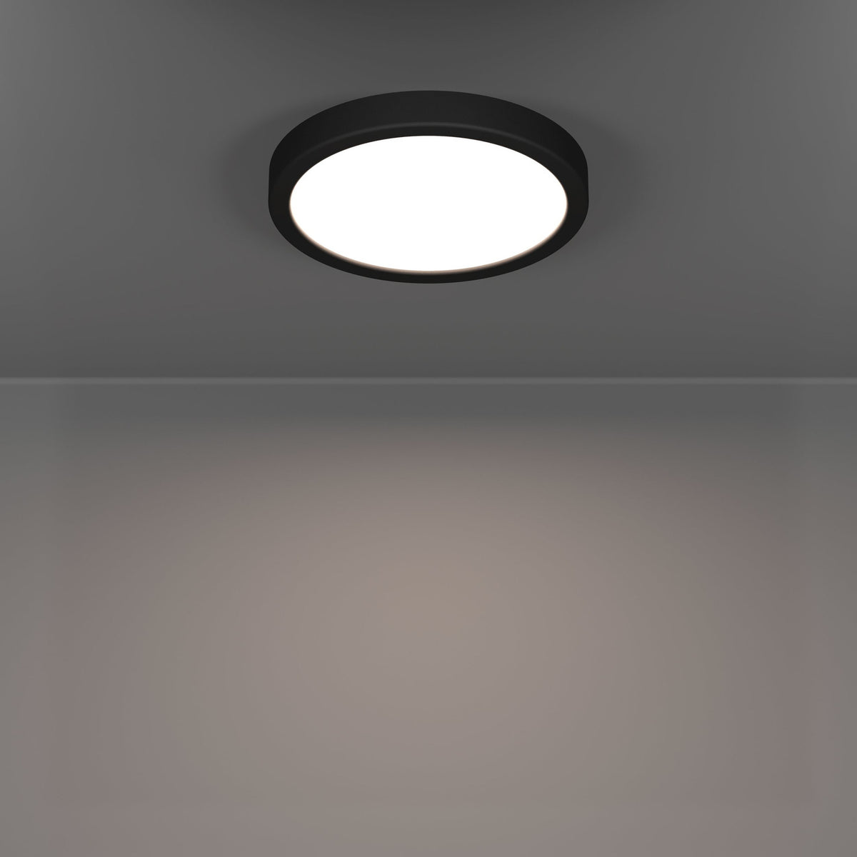 Round Gosmelle LED downlight with black plastic trim and white diffuser, mounted on a grey ceiling, illuminating the room below with warm white light.