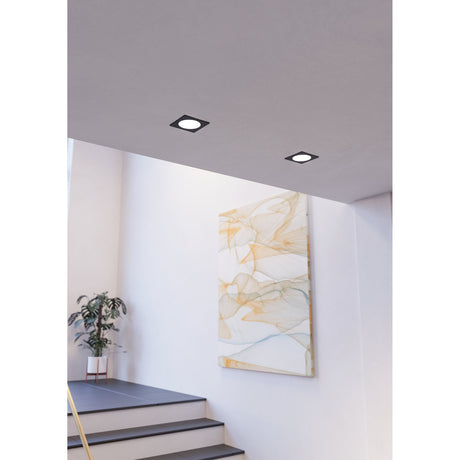 Gosmelle LED Downlight 21.6cm in black, square recessed fixtures with round white diffusers, shown installed in a light grey staircase ceiling above a marble-effect wall art.