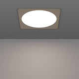 Gosmelle LED Downlight 21.6cm in satin nickel, square plastic trim with round white diffuser, mounted on a grey ceiling above a plain room.
