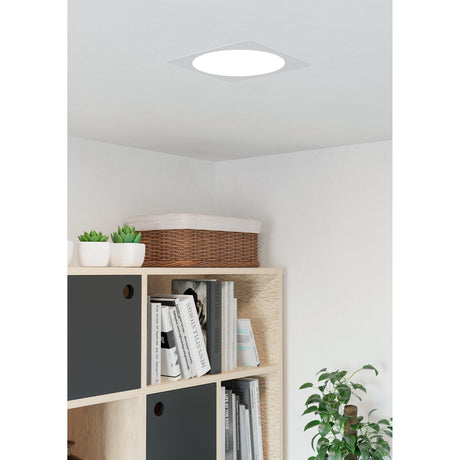 Gosmelle LED Downlight 21.6cm in white, square plastic trim with round diffuser, shown fitted into a white ceiling above a bookshelf in a living space.