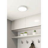Gosmelle round LED downlight in white, 21cm slim ceiling fixture shown mounted above white kitchen cabinets with a shelf and hooks beneath.