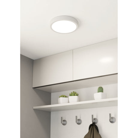 Gosmelle round LED downlight in white, 21cm slim ceiling fixture shown mounted above white kitchen cabinets with a shelf and hooks beneath.