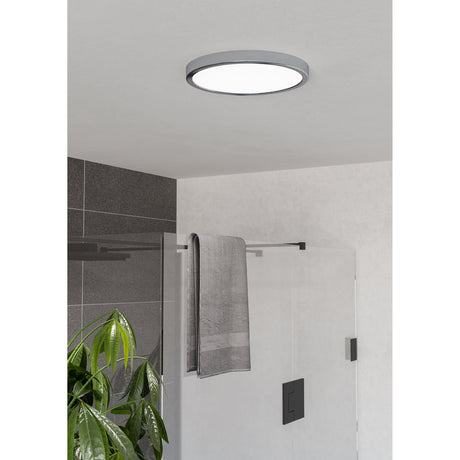Gosmelle LED Downlight 27.8cm in chrome, round ceiling-mounted fixture with white diffuser, shown installed in a bathroom with glass shower screen.