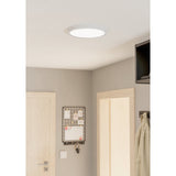 Gosmelle round LED downlight in white steel with a wide diffuser, fitted flush to a hallway ceiling near a door, pinboard, and wall-mounted TV.