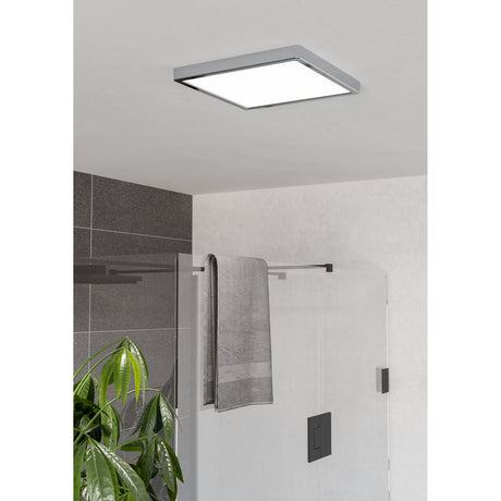 Gosmelle LED Downlight 29 x 29cm in chrome, a square flush ceiling light with white diffuser, shown installed above a bathroom shower enclosure.