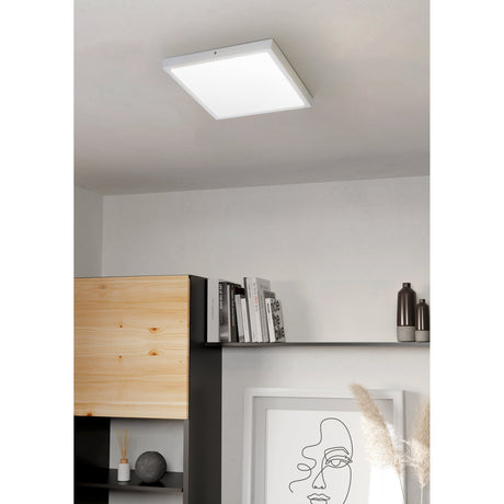 Gosmelle LED Downlight 40 x 40cm in white, square aluminium frame with plastic diffuser, shown fitted flush on a living room ceiling above a bookshelf and wall art.