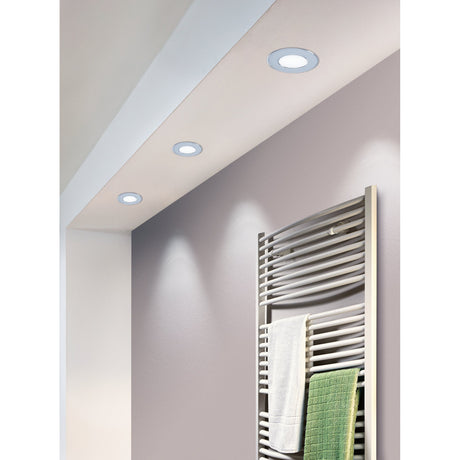 Gosmelle LED Downlight in chrome with round white diffuser, recessed into a bathroom ceiling above a wall-mounted towel radiator.