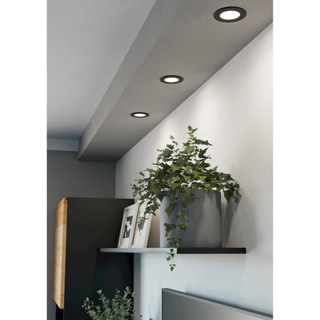 Gosmelle LED downlights with round black plastic trims and white diffusers recessed into a sloped ceiling above a shelf with a potted plant and framed photos.