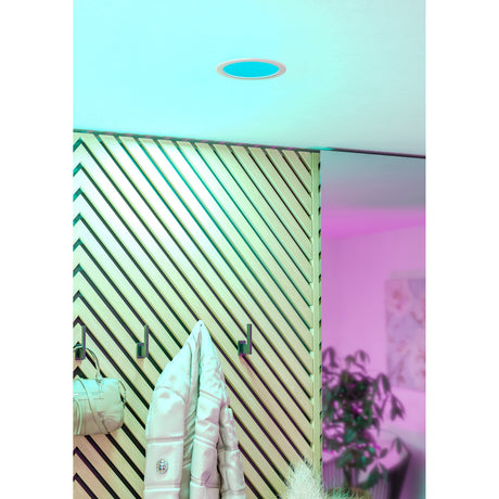 Gosmelle round recessed LED downlight in white, 16.8cm, shown glowing turquoise-blue in a ceiling, with pink ambient lighting visible in the room beyond.