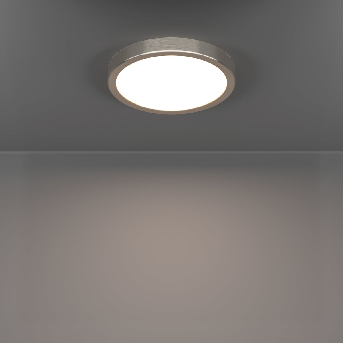 Gosmelle smart LED downlight in satin nickel, a slim round ceiling fixture with a brushed metal rim and white diffuser, shown illuminated on a grey ceiling.