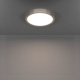 Gosmelle smart LED downlight in satin nickel, a slim round ceiling fixture with a brushed metal rim and white diffuser, shown illuminated on a grey ceiling.