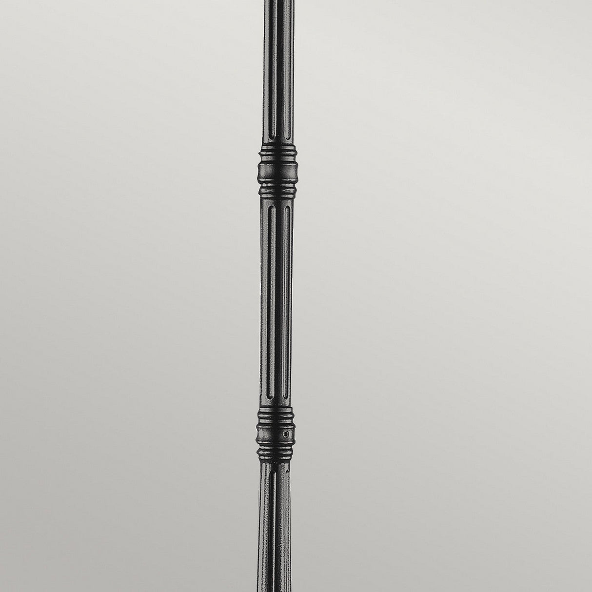 A close-up of the Grampian 1 Light Lamp Post – Black, showcasing its decorative ridges on a cast aluminum rod against a plain gray background. Ideal for enhancing outdoor lighting.