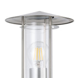 Close-up of the Granette outdoor wall light's stainless steel hat-shaped cap and clear glass cylinder with an exposed E27 filament bulb, set against a white background.