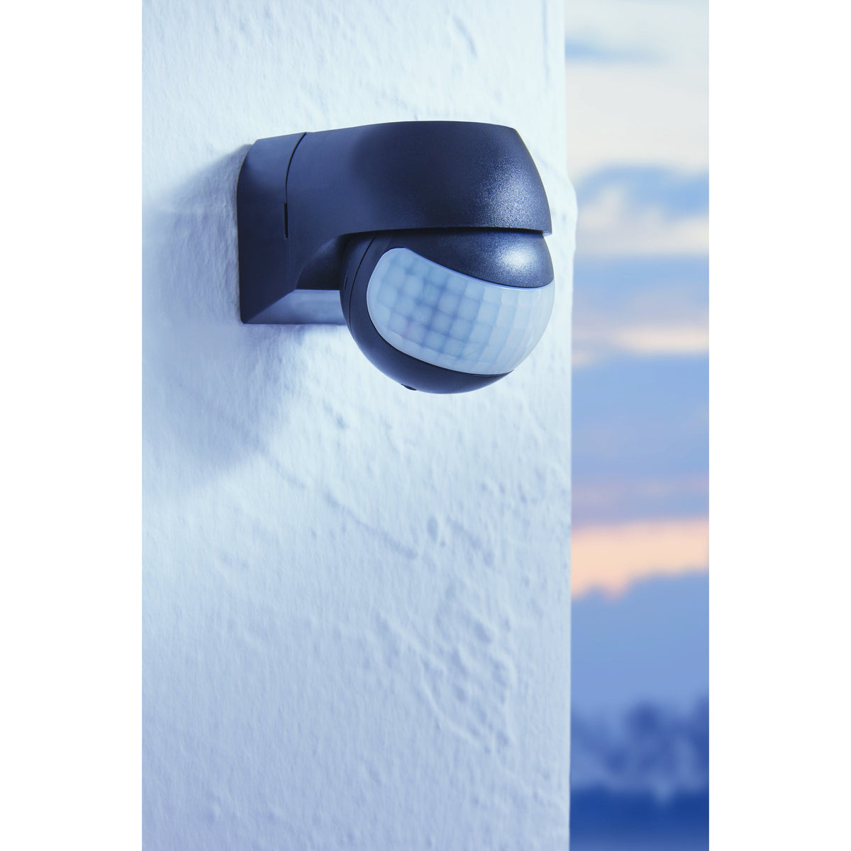 Granvena PIR Sensor 180° in black plastic, wall-mounted outdoors with curved hood and ball-shaped head featuring a white faceted lens.