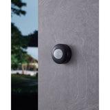 Granvena PIR Sensor 360° in black, a compact round motion sensor with a white domed lens, mounted on a grey stone-textured wall.