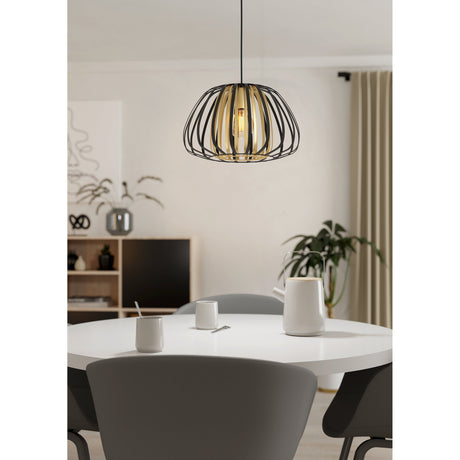 Grilvessa Pendant Light 37.5cm in black and gold, round open cage steel shade over a dining table in a modern living room setting.