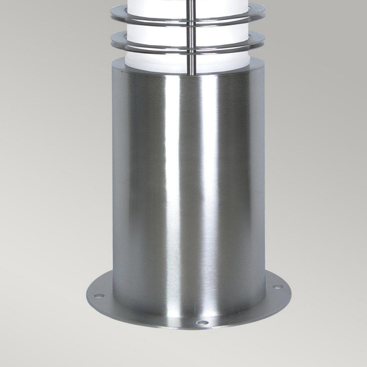 Close-up of the Sandbanks 1 Light Mini Bollard in silver against a neutral background. The cylindrical base features a white frosted shade accented by horizontal metal rings, providing sleek and contemporary outdoor lighting.