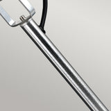 Close-up of the Spennymoor stainless steel spotlight and pole, showcasing a minimalist, modern design ideal for garden lighting. The lamp boasts a sleek silver finish and straightforward framework, set against a plain, light gray background.