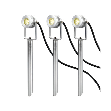 Three elegant silver spotlights from the Spennymoor Kit, each featuring a black cord and mounted on a long spike, are lined up against a white background. These 12V LED garden lights are ideal for enriching your outdoor lighting ambiance.