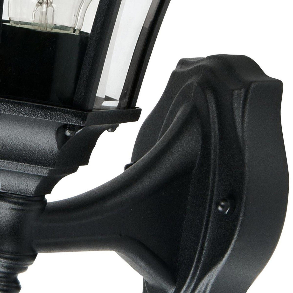 Close-up of the black Ledbury 1 Light Wall Lantern, crafted from cast aluminum with a traditional design. It features a glass enclosure mounted on a decorative backplate, angled slightly to highlight its classic styling and metallic finish—ideal for enhancing decorative exterior lighting.