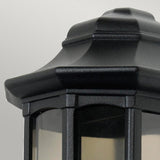 Close-up of a Newbury 1 Light Half Lantern in black, featuring clear glass panels against a light gray background. This decorative exterior lighting piece showcases a classic, angular design crafted from cast aluminum with a slightly tapered top.