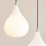 Drops Glass Pendant Light 23cm in Opal & Steel, teardrop-shaped opal glass shade with polished steel neck and black flex, shown paired against a light neutral background.