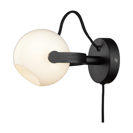 DC Wall Light 12cm in Opal, Oak & Black featuring a white opal glass sphere on a dark oak arm with a round black backplate and fabric cable, shown on a white background.