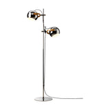 DC 2 Light Floor Lamp in chrome, featuring two round adjustable shades on oak-accented arms along a slim stem with a flat disc base, set against a white background.