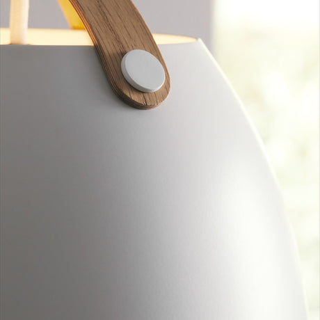 Close-up of the Oslo Pendant Light 40cm in white and oak, showing the glossy white dome shade with an arched oak strap handle pinned by a white boss.
