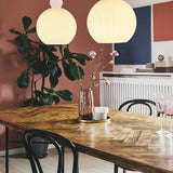 Two Ball Pendant Lights 32cm in ribbed opal glass with rounded knops, hung above a wooden dining table in a terracotta-walled dining room.