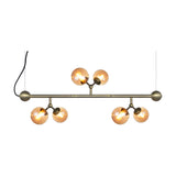 Atom Mini Horizontal 6 Light Chandelier in antique brass, a horizontal bar suspended on wires with six amber glass globes branching in pairs, shown on a white background.