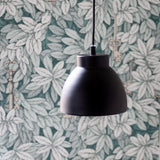 Object Pendant Light 16cm in matte grey with a stepped cylindrical shade and open rim, hanging on a black cord against a leaf-patterned wall.