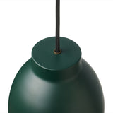 Close-up of the Object Pendant Light 16cm in green, showing the matte metal dome shade with a narrow top cylinder, black fabric cord, and brass cord grip against a white background.