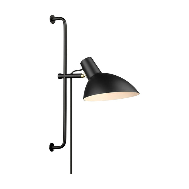 Metropole Grande Wall Light in black, a wide angled dome shade with pale interior on a short arm and brass collar, mounted on a long black wall rail, shown on a plain white background.