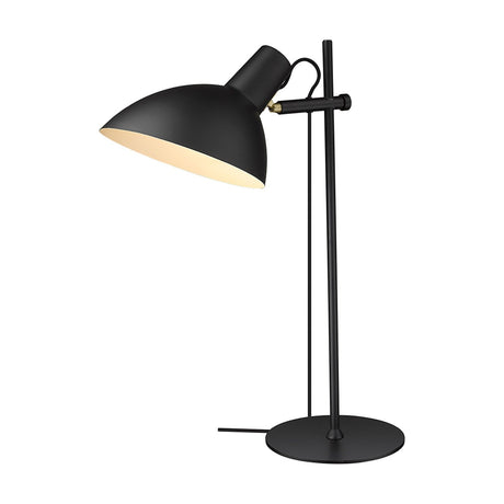 Metropole Table Lamp in black with a matte dome shade, pale interior lining, adjustable brass hinge, slim upright stem, round base, and visible cable, shown on a white background.