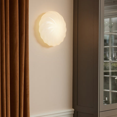 Twist Wall Flush Ceiling Light 35cm in opal glass with a swirled ribbed dome, mounted on a wall beside a curtain and cabinet in a living room setting.