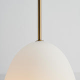 Bodø Pendant Light 20cm close-up showing the opal white egg-shaped glass shade and slim brass sleeve against a plain light grey background.